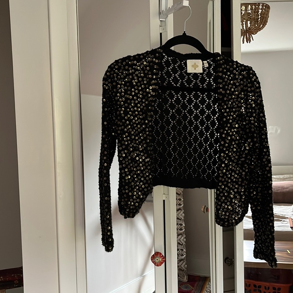 Black small cardigan with brass metal gold sequins from an Anthropology brand.